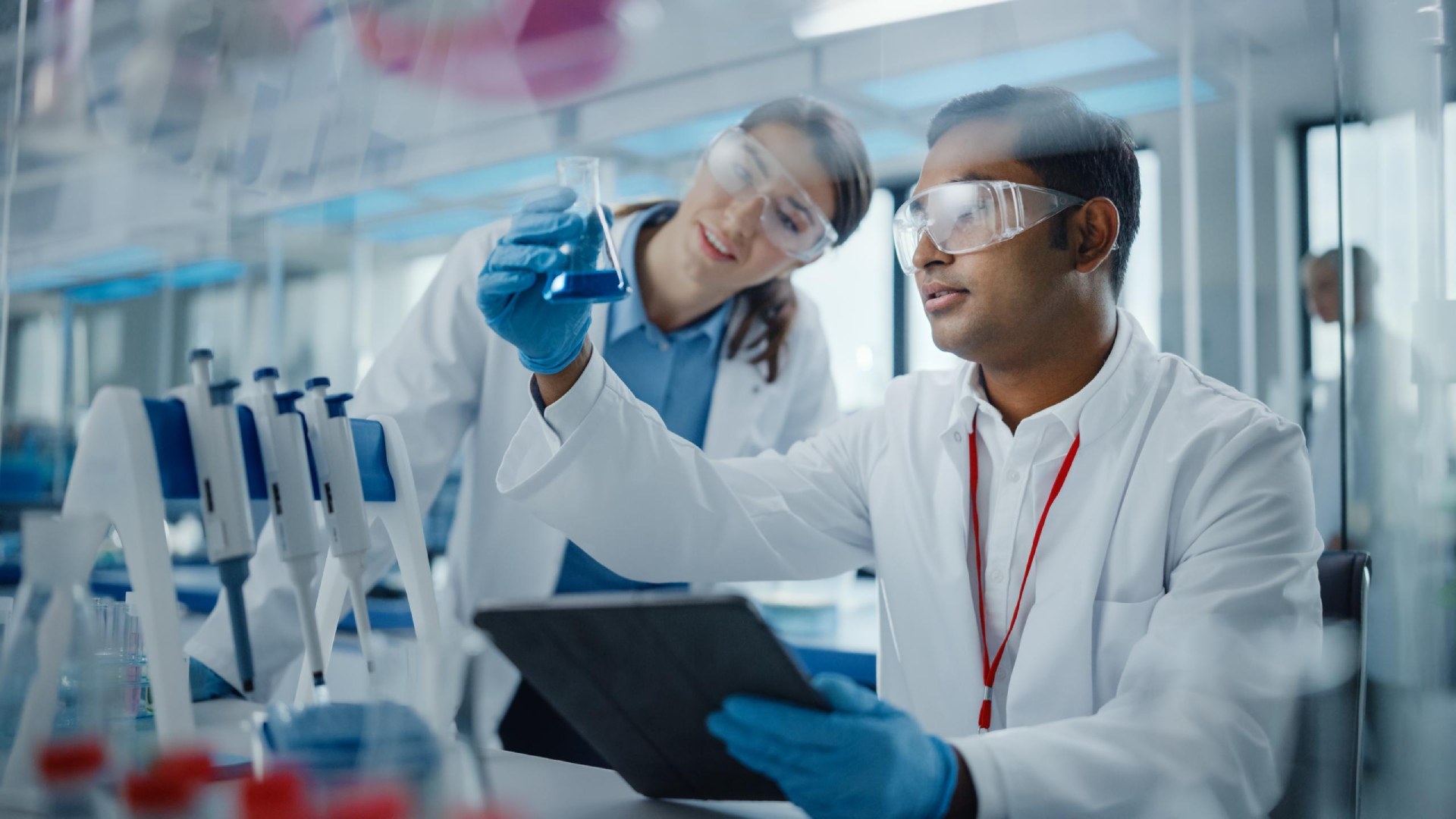 Scientists in laboratory examining sample